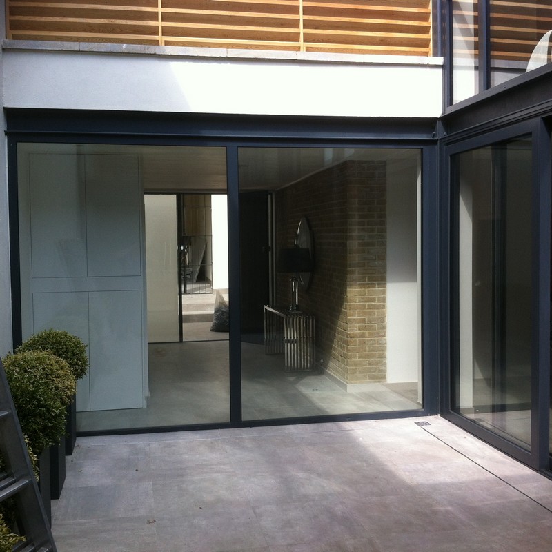 Floor-to-ceiling sliding doors opening to courtyard in Catford