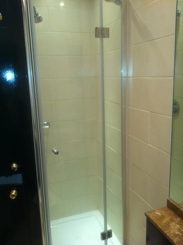 Frameless glass shower enclosure with chrome fittings in Catford
